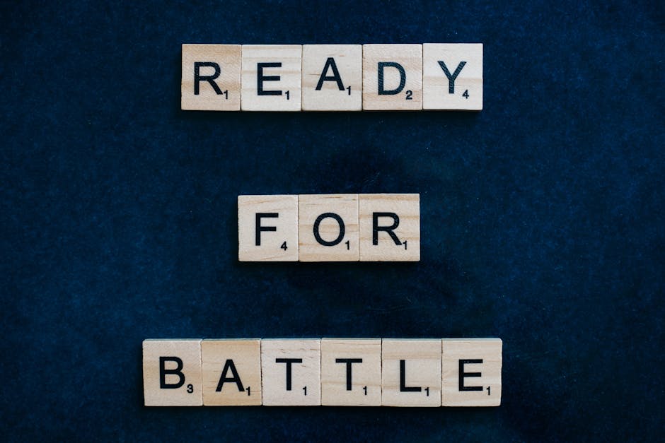 Scrabble tiles spell 'Ready for Battle' on a blue background, symbolizing motivation and readiness.